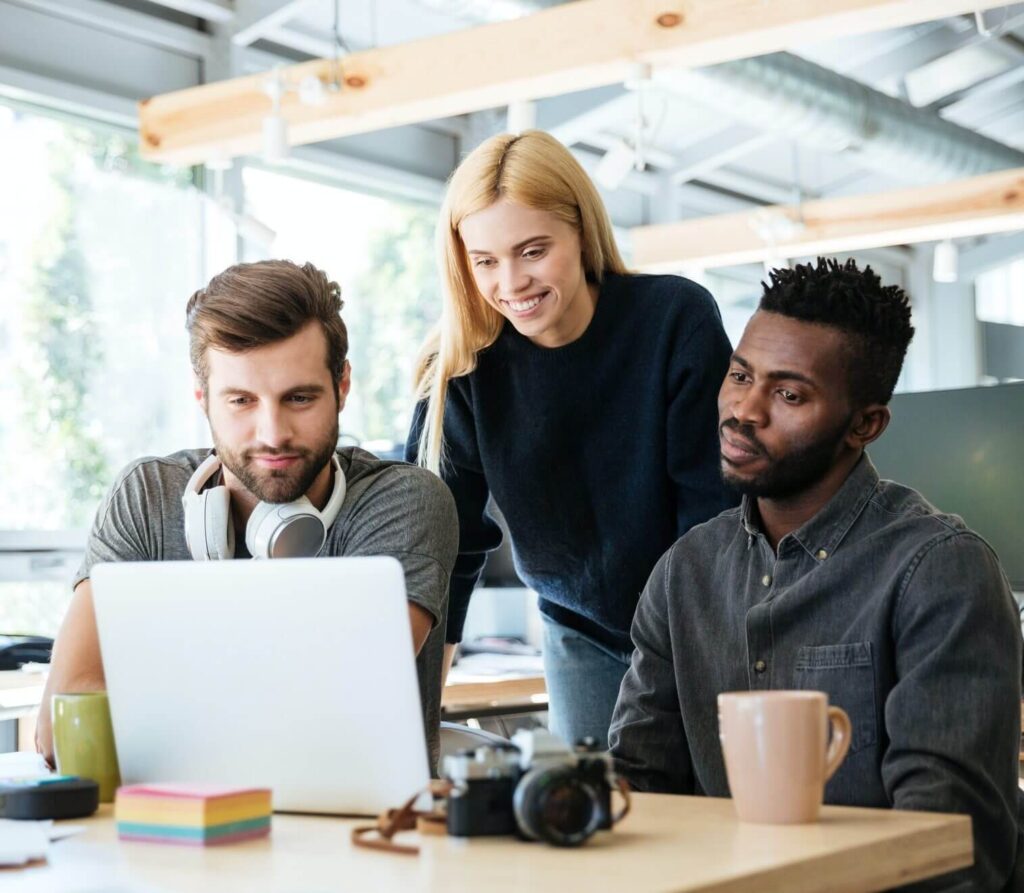 happy colleagues sitting in office coworking e1617897505461 1 - Acceltor Solutions